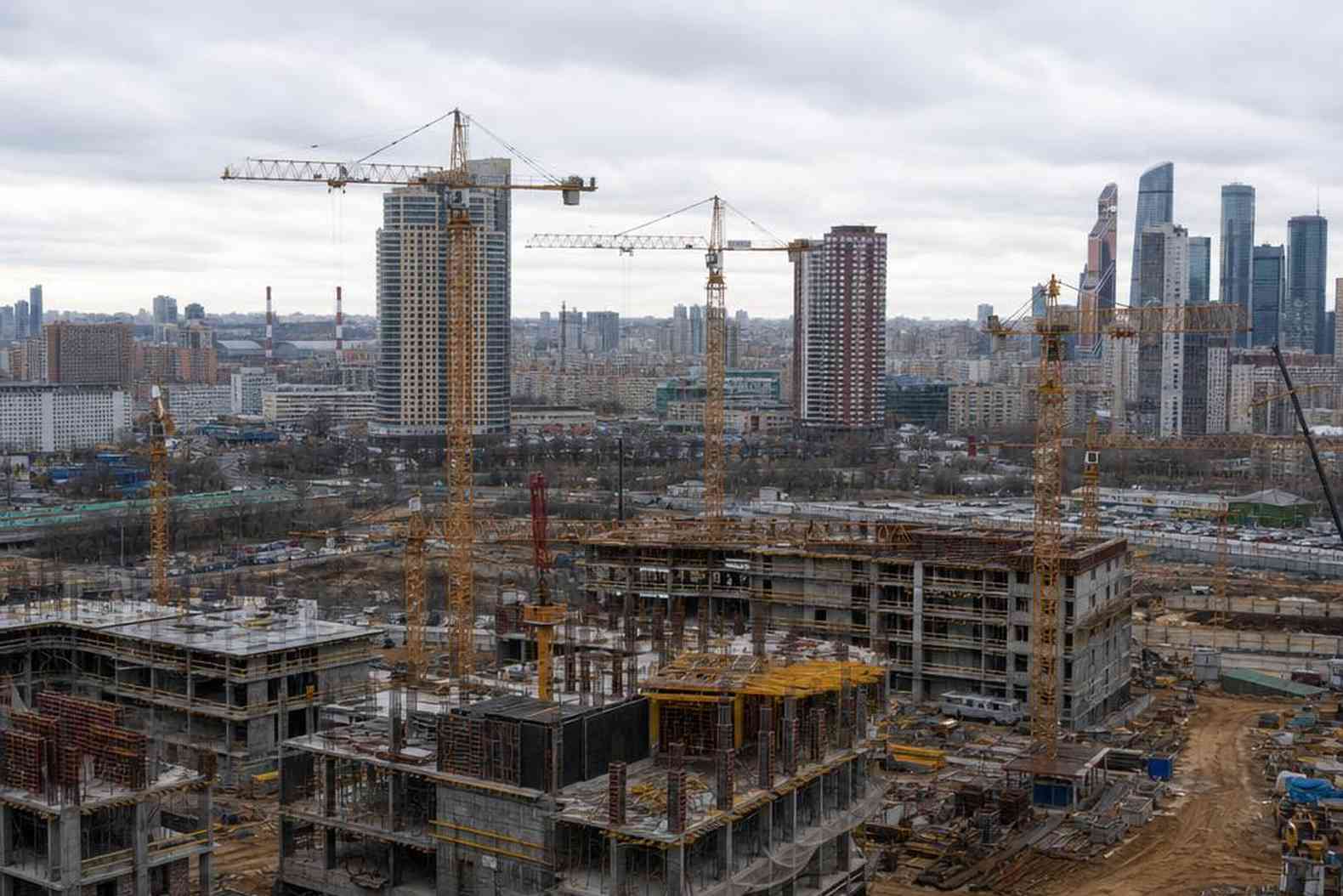 Панорама московского района с башенными кранами над жилой стройкой